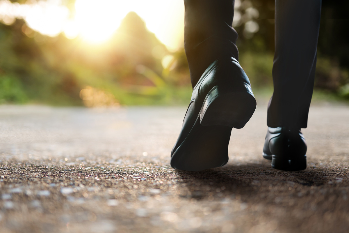 Men's Feet in Leather Shoes Walking on Ground